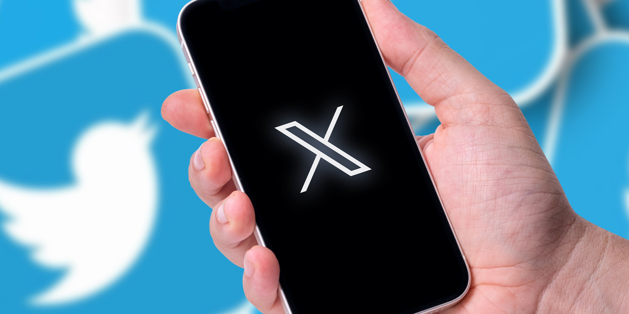 Twitter X logo on smartphone and Twitter logo in background